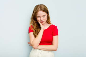 Fototapeta premium Young caucasian woman isolated on blue background who is bored, fatigued and need a relax day.