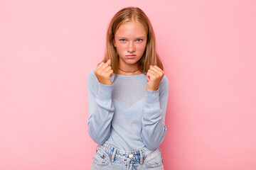 Caucasian teen girl isolated on pink background showing fist to camera, aggressive facial expression.