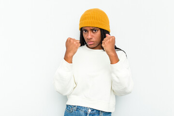 Young African American woman isolated on white background throwing a punch, anger, fighting due to an argument, boxing.