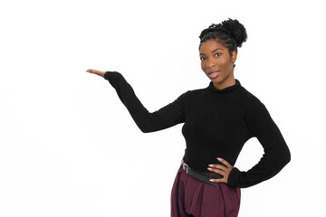 Portrait of welcoming African American woman. Female model in black long sleeve shirt and trousers standing against white background and showing copy space. Portrait, emotion concept