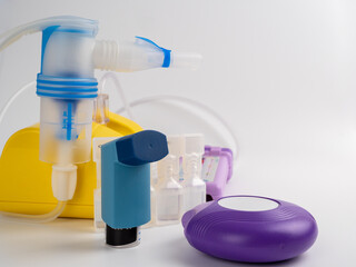 Asthma medicine. A set of inhalers and drugs for the treatment of bronchial asthma on a white...