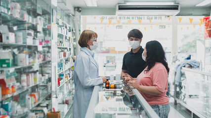 Pharmacists provide drug advice to male and female customers.female doctor healt care of pharmacy...