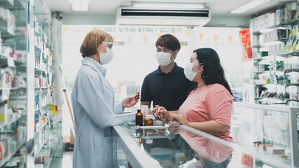 Pharmacists provide drug advice to male and female customers.female doctor healt care of pharmacy customer health.doctor giving prescription.