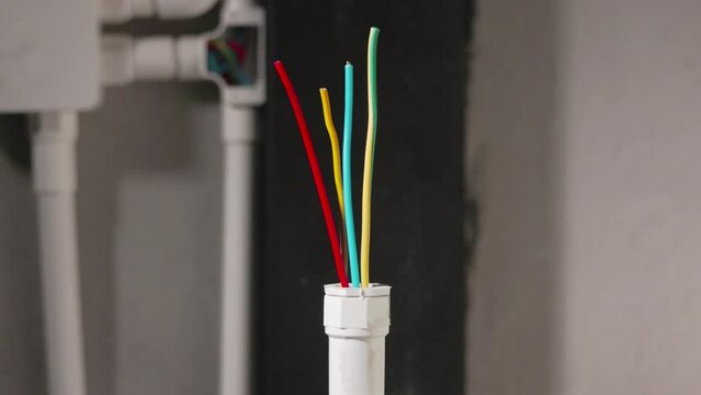 Electrician repair wire in PVC Conduit , renovate home .