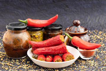 Traditional Homemade Red Chilli Pickle Also Known As Moti Teekhi Lal Mirch Ka Bharwa Bharua Achar Stuffed With Coarsely Powdered Masala Spices Like Seeds Mustard, Fenugreek, Turmeric, Amchur And Hing