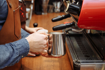 Making coffee in a coffee shop on a coffee machine, hands with a cup