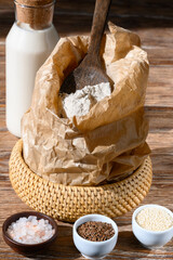 Ingredients for baking and milk on dark wooden table Close-up