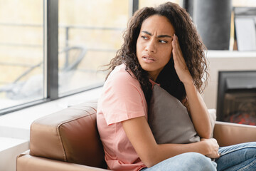 Sad disappointed depressed young african woman suffering from migraine headache coronavirus periods...