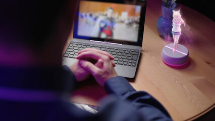 Person watch movie on laptop with 3D anime girl hologram beside interacting