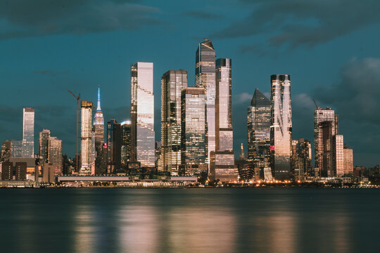 Manhattan midtown skyline, seen from across the Hudson River at night. Beautiful reflections and light. High quality photo
