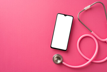Fototapeta na wymiar Breast cancer awareness concept. Top view photo of pink stethoscope and smartphone on isolated pink background with blank space