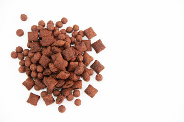 dry children's sweet chocolate breakfast balls and pads on a white background, isolate