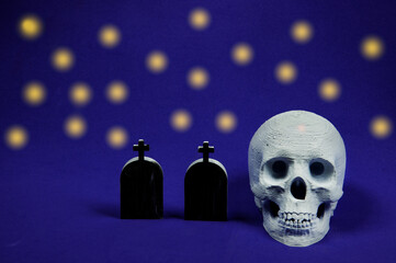 Halloween skull and tombstones with purple background