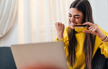 Cheerful adult young woman, happy with her online purchase.