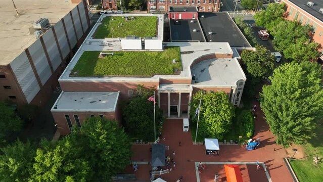 Green rooftop garden on urban city building in USA. American flag in Charlottesville Virginia. Aerial view.