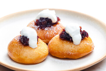 fried muffins with plum jam and sour cream