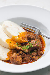 beef goulash served with dumplings