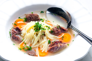 beef broth with noodles and carrot