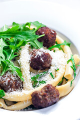 pasta macaroni with meat balls and arugula