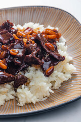 beef meat with soya sauce and peanuts served with white rice