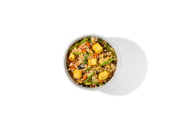 Fried rice with vegetables, chicken and tofu cheese isolated on white background Traditional chinese food - fried rice with egg in ceramic bowl. Bowl with fried rice, chicken and tofu