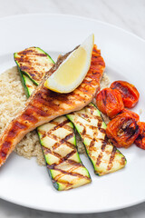 grilled poultry meat with tomatoes zucchini served with couscous
