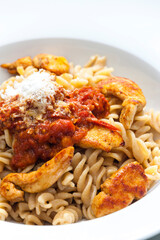 pasta fusilli with spicy chicken meat and tomato sauce