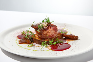 Baked camembert in parma ham on brioche with berry jam. Elegant food - hot appetizer of camembert and ham in summer menu. Cheese appetizer in fine dining. Summer menu.