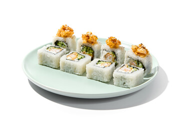 Sushi with shrimp and cucumber inside, rice outside topped salmon tartare. Maki sushi with salmon, shrimp and cucumber on ceramic plate Shrimp maki isolated on white background with hard shadow