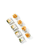 Maki sushi with rice outside, tempura shrimp inside topped salmon tartare. Shrimp and salmon maki roll isolated on white background Trendy sushi roll with burnt salmon fish and hard shadows