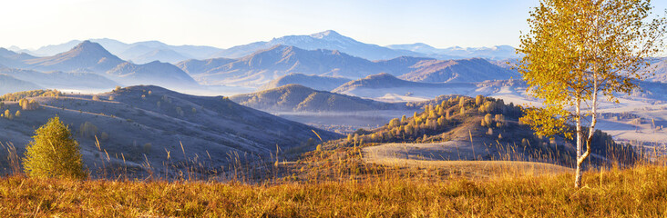 Beautiful panoramic view of autumn nature. Mountain landscape, morning haze.