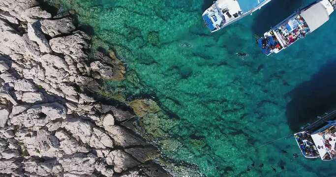 Rising over Canyon Diving Site and rocky small islands top view video. High altitude view of crystal clear Aegean Sea. Area close to Meis Island and Kaş Town.