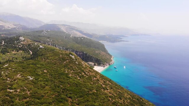 Aerial Drone View of Gjipe Beach and Canyon, Dhermi, Albania - Hidden Paraside with boats, tourists, sunbeds and blue sea