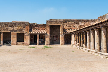 Patio in front of exterior facade of ancient roman house in Pompeii