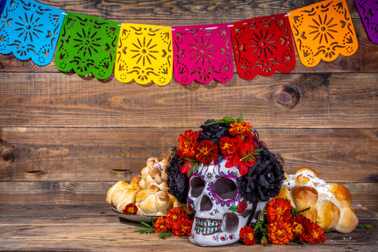 Spanish Mexican traditional holiday, autumn festival Day of the Dead (dia de los muertos) background. With traditional Pan de Muerto bread, decorations and marigold and cempasuchil  flowers