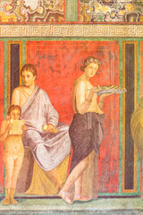 Close-up on colorful ancient roman fresco decorating house wall in Pompeii showing a domestic scene