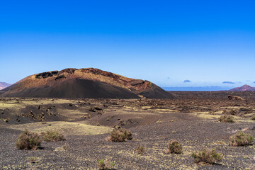 Close up view of the Volcan del Cuervo and the sea of solidified lava around it. Photography made in Lanzarote, Canary Islands, Spain.