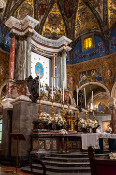 Close-up on altar beneath decorated cupola inside catholic church in Naples, Italy