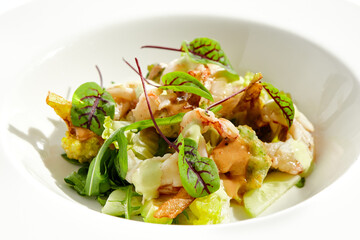 Green salad with broccoli, avocado, shrimps on white plate. Healthy dinner - Salad broccoli and prawns. Clean eating. Green bowl with vegetables and shrimps Tempura broccoli with avocado, leaf, prawn.