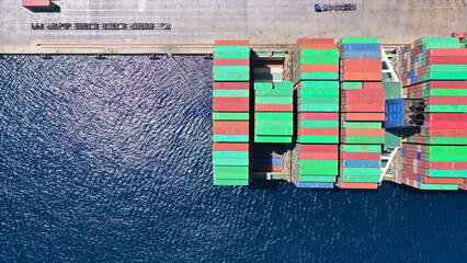 Aerial drone top down photo of container tanker ship anchored in loading - unloading Mediterranean terminal port
