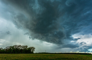 Fototapeta na wymiar Storm clouds over field, tornadic supercell, extreme weather, dangerous storm