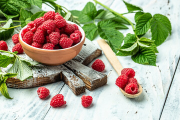 Raspberry in bowl on light background. Organic Raspberry. Red berry. top view with copy space