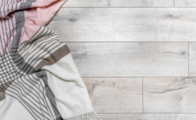 Warm blanket on the background of the laminate. Beautiful soothing colors.