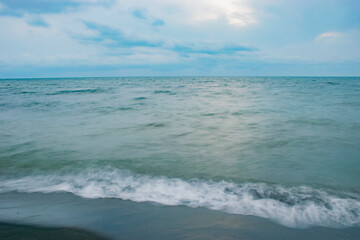 Fototapeta na wymiar waves on the dark blue sea beach