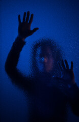 Shadow of woman screaming behind the glass, domestic violence concept.