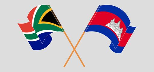 Crossed and waving flags of South Africa and Cambodia
