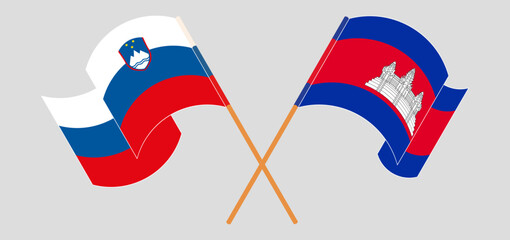 Crossed and waving flags of Slovenia and Cambodia