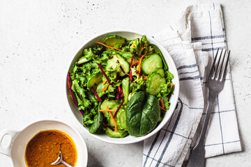 Green salad bowl with mustard dressing.
