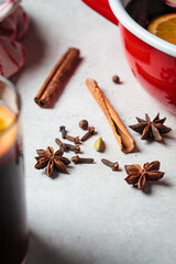 Spices for cooking mulled wine. Cinnamon, star anise, cardamom and cloves on gray background.