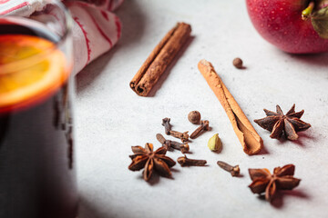 Spices for cooking mulled wine. Cinnamon, star anise, cardamom and cloves on gray background.